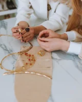 Close-up of hands examining elegant - Credits: pexels