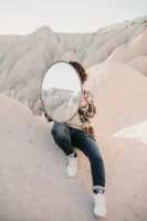 Person holding a mirror reflecting - Credits: pexels