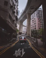 Taxi drives through a city - Credits: pexels