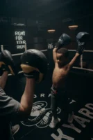 A child boxer raises gloves - Credits: pexels