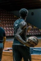Athlete in jersey practicing basketball - Credits: pexels