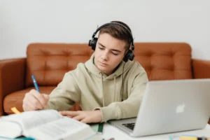 Teenage boy with headphones, focused - Credits: pexels