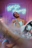 Smiling woman holding a pineapple - Credits: pexels