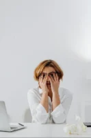 A stressed woman in eyeglasses - Credits: pexels
