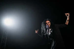 A vibrant female singer passionately - Credits: pexels