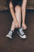 A woman sitting on a - Credits: pexels