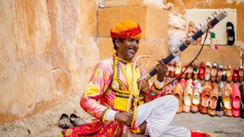 Colorful Rajasthani musician playing traditional - Credits: pexels