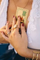 Close-up of woman holding tarot - Credits: pexels