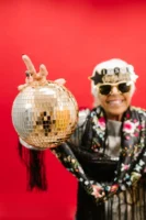 Cheerful senior woman holding a - Credits: pexels