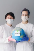 Two healthcare professionals in masks - Credits: pexels