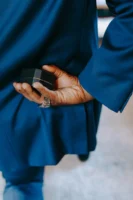 Man in blue suit holding - Credits: pexels