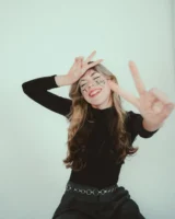 Playful young woman with text - Credits: pexels