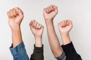 Four diverse fists raised in - Credits: pexels