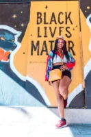 Stylish woman poses confidently against - Credits: pexels