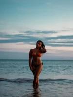 Woman in a bikini standing - Credits: pexels