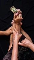 Close-up of multiple hands reaching - Credits: pexels