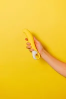 A hand holding a yellow - Credits: pexels