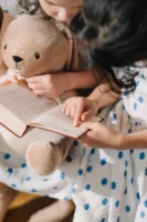 Two girls reading a book - Credits: pexels