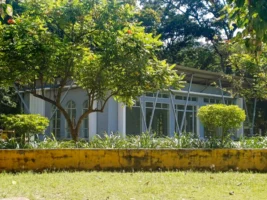 A modern glass building surrounded - Credits: pexels