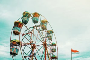 Colorful ferris wheel and flag - Credits: pexels