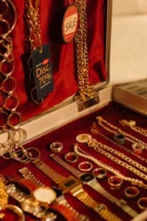 Close-up of gold jewelry including - Credits: pexels