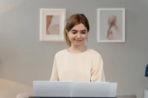 A young woman smiling while - Credits: pexels