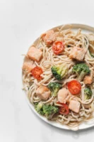 Tasty plate of salmon carbonara - Credits: pexels