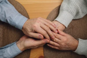 Close-up of elderly hands holding - Credits: pexels