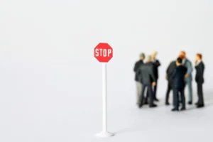 A miniature stop sign stands - Credits: pexels